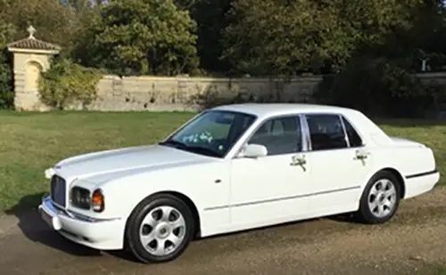 Old White Bentley wedding car side view in Ipswich